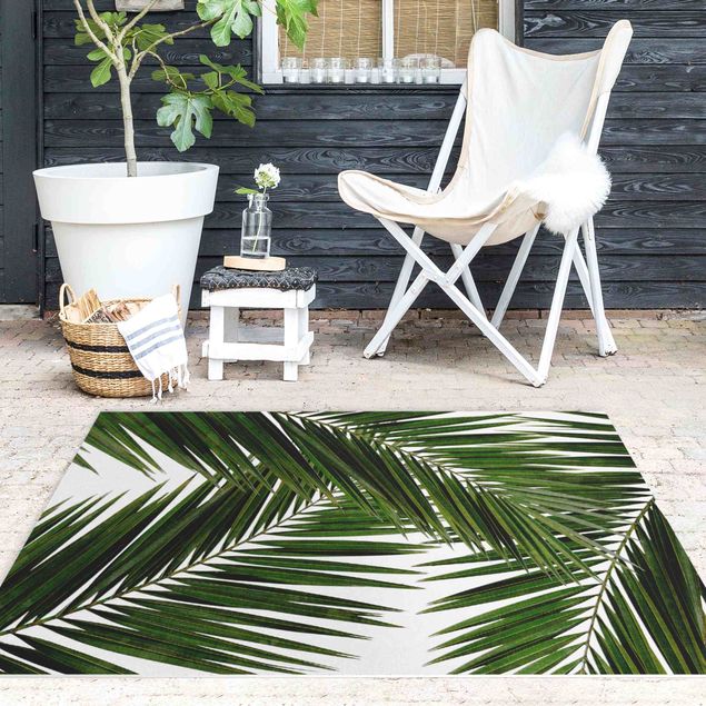 tappeto ingresso esterno Vista attraverso le foglie di palma verde