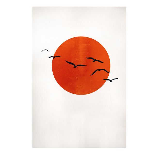 Stampe su tela paesaggio Stormo di uccelli di fronte al sole rosso I