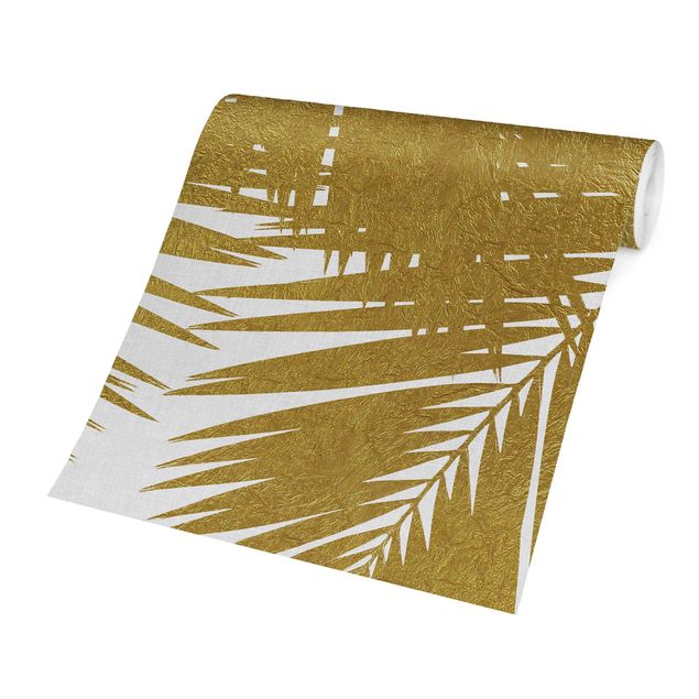 Carte da parati paesaggio Vista attraverso le foglie di palma dorate